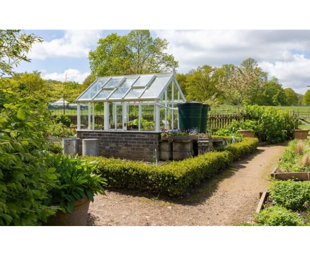 Green house in a garden using solar heating